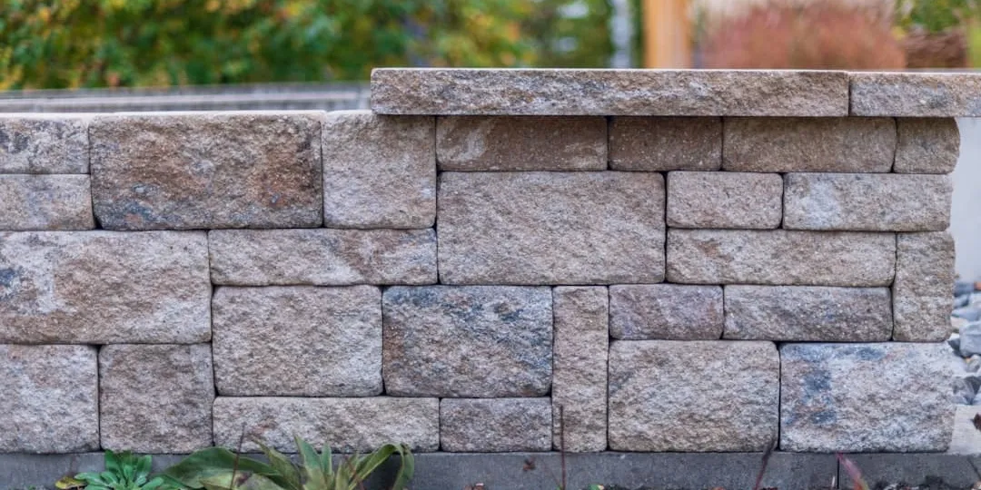 Stone retaining wall in a landscaped yard